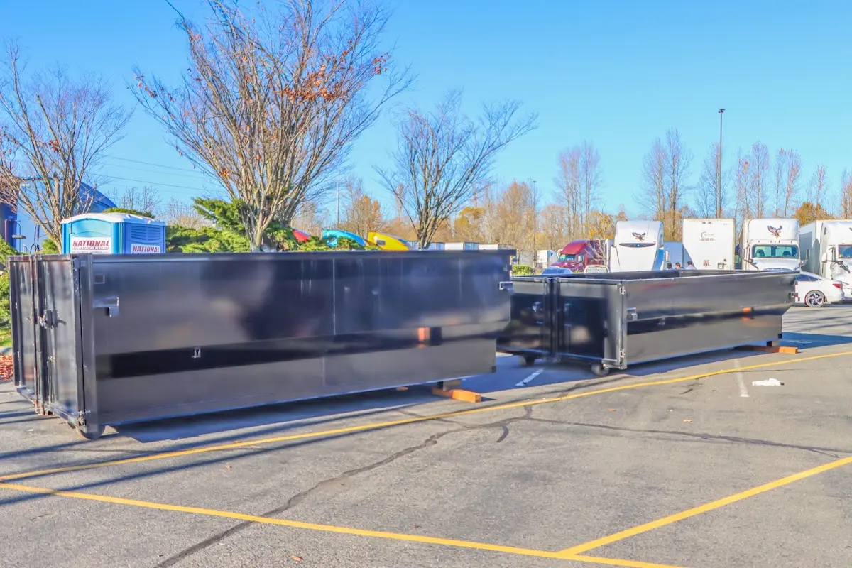 Professional dumpster rental service with roll-off container on residential driveway in Wake Village